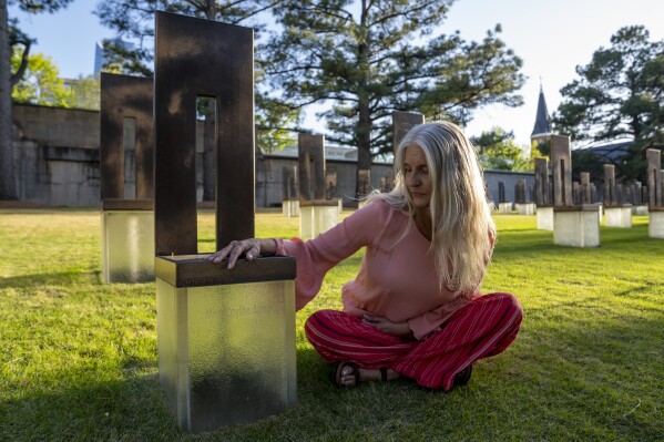 Aren Almon poses for a portrait next to the memorial chair for her daughter, Baylee Almon, at the Oklahoma City National Memorial on Wednesday, April 9, 2025 in Oklahoma City. (AP Photo/Nick Oxford)