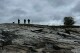Bird watchers look out under dark skies at Kettle Cove State Park, Thursday, May 22, 2025, in Cape Elizabeth, Maine. (AP Photo/Patrick Whittle)