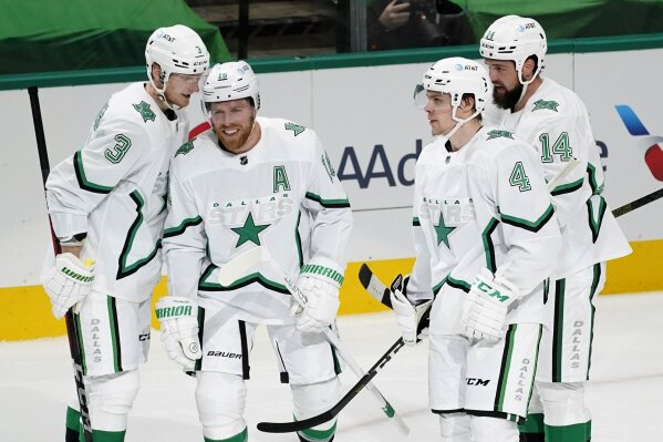 CORRECTS CHANGES SECOND PLAYER FROM LEFT TO PAVELSKI NOT COMEAU-Dallas Stars’ John Klingberg (3), Joe Pavelski (16), Miro Heiskanen (4), and Jamie Benn (14) celebrate a goal scored by teammate Roope Hintz in the first period of an NHL hockey game against the Detroit Red Wings in Dallas, Monday, April 19, 2021. Klingberg and Heiskanen were credited with an assist on the score. (AP Photo/Tony Gutierrez)