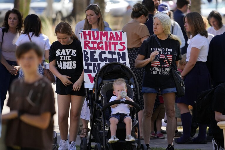 Anti-abortion supporters stand outside the Capitol, Wednesday, May 1, 2024, in Phoenix. (AP Photo/Matt York)