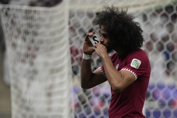 Qatar's Akram Afif celebrates after scoring his side's opening goal during the Asian Cup final soccer match between Qatar and Jordan at the Lusail Stadium in Lusail, Qatar, Saturday, Feb. 10, 2024. (APPhoto/Aijaz Rahi)