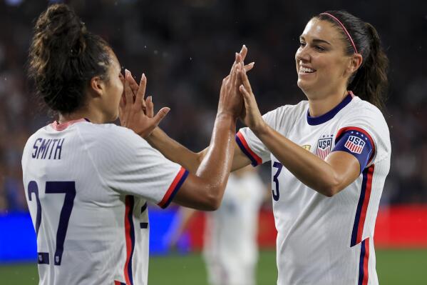 United States forward Alex Morgan, right, high-fives Sophia Smith after scoring a goal during the second half of an international friendly soccer match against Paraguay, Tuesday, Sept. 21, 2021, in Cincinnati. The United States won 8-0. (AP Photo/Aaron Doster)