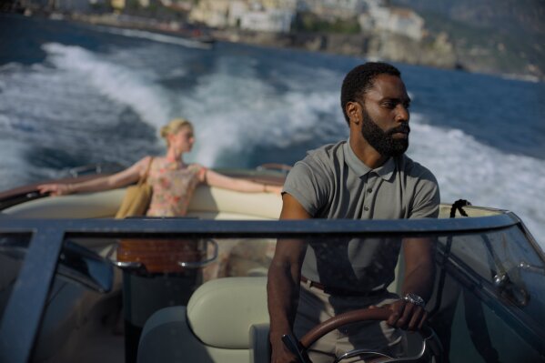 This image released by Warner Bros. Entertainment shows Elizabeth Debicki, left, and John David Washington in a scene from "Tenet."  (Melinda Sue Gordon/Warner Bros. Entertainment via AP)