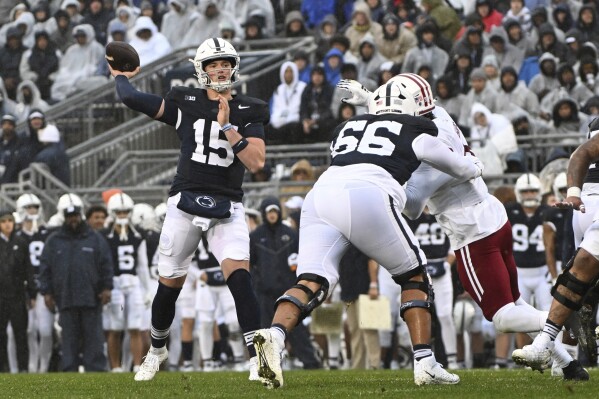 Penn State quarterback Drew Allar (15) throws a touchdown pass to tight end Tyler Warren (44) during the first half of an NCAA college football game against Massachusetts, Saturday, Oct. 14, 2023, in State College, Pa. (AP Photo/Barry Reeger)