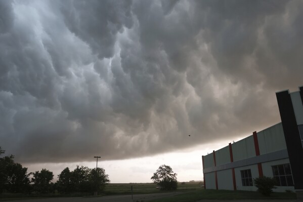 Severe storm clouds move across the northwest edge of Davenport, Iowa on Friday, May 24, 2024. Several tornadoes were reported in Iowa and Illinois as storms downed power lines and trees on Friday, just after a deadly twister devastated one small town.(Roy Dabner/Quad City Times via AP)