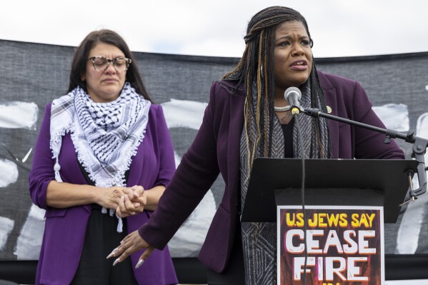 FILE - Rep. Cori Bush, D-Mo., speaks as Rep. Rashida Tlaib, D-Mich., listens during a demonstration calling for a ceasefire in Gaza near the Capitol in Washington, Oct. 18, 2023. A group of progressive lawmakers are fighting back against a multi-million dollar campaign to push them out of Congress for their vocal opposition to Israel's deadly bombardment of Gaza after the Oct. 7 attack. (AP Photo/Amanda Andrade-Rhoades, File)