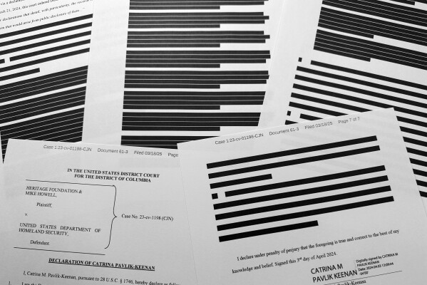 A heavily redacted declaration by Catrina Pavlov Keenan is photographed Tuesday, March 18, 2025, as newly released court documents shed no fresh light on the circumstances under which Prince Harry entered the United States. (AP Photo/Jon Elswick)