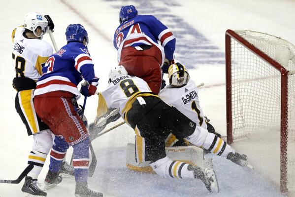 New York Rangers right wing Kaapo Kakko (24) collides with Pittsburgh Penguins goaltender Casey DeSmith (1) in the third period of Game 1 of an NHL hockey Stanley Cup first-round playoff series, Tuesday, May 3, 2022, in New York. Goalie interference was called on the play. (AP Photo/Adam Hunger)