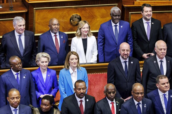 Italian Premier Giorgia Meloni, center, poses for a family photo with, back row from left; Italian Foreign Minister Antonio Tajani, African Union President Azali Assoumani, African Union Commission Chairperson Moussa Faki Mahamat, back row second from right, Vice President of the Council of Ministers of Italy Matteo Salvini, back row right, President of the European Commission Ursula von der Leyen, second from left, second row, President of the European Parliament Roberta Metsola, President of the European Council Charles Michel and President of Tunisia Kais Saied, at the start of an Italy - Africa summit, in Rome, Monday, Jan. 29, 2024. Meloni opened a summit of African leaders on Monday aimed at illustrating Italy's big development plan for the continent that her government hopes will stem migration flows and forge a new relationship between Europe and Africa. (Roberto Monaldo/LaPresse via AP)