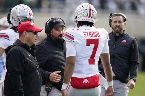 Ohio State head coach Ryan Day, center talks to quarterback C.J. Stroud during the first half of an NCAA college football game against Michigan State, Saturday, Oct. 8, 2022, in East Lansing, Mich. (AP Photo/Carlos Osorio)