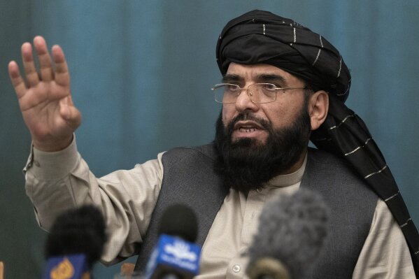 Suhail Shaheen, member of negotiation team gestures while speaking during a joint news conference in Moscow, Russia, Friday, March 19, 2021.  The Taliban warned Washington against defying a May 1 d...
