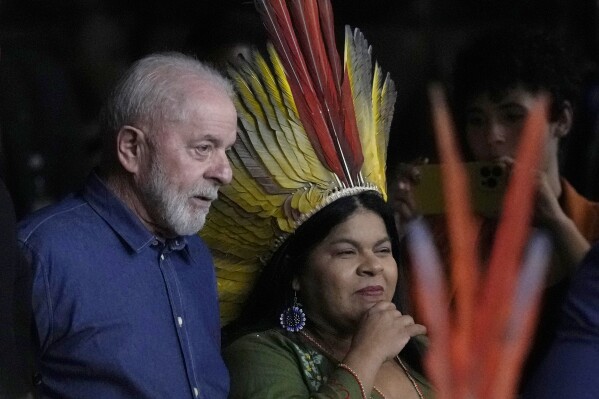 Brazil's President Luiz Inacio Lula da Silva and Minister of Indigenous Peoples Sonia Guajajara arrive to the closing ceremony of the 1st Ordinary Meeting of the National Council for Indigenous Policy, in Brasilia, Brazil, Thursday, April 18, 2024. The council, dissolved in 2019, was revived in 2023. (AP Photo/Eraldo Peres)