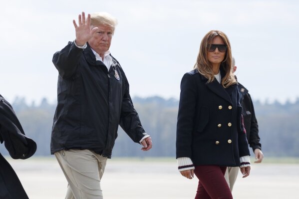 
              FILE - In this March 8, 2019 file photo, President Donald Trump and first lady Melania Trump walk from Marine One to board Air Force One at Lawson Army Airfield, Fort Benning, Ga., en route Palm Beach International Airport in West Palm Beach, Fla., after visiting Lee County, Ala., where tornados killed 23 people. Trump has had it with the #fakeMelania conspiracy theories circulating on social media. Trump is claiming that photos of his wife were altered to make it appear that a look-alike accompanied him to Alabama last week. (AP Photo/Carolyn Kaster)
            
