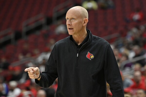 FILE - Louisville head coach Chris Mack directs his team during an NCAA college basketball intrasquad scrimmage in Louisville, Ky., Saturday, Oct. 16, 2021. College of Charleston has hired former Louisville coach Chris Mack as its men's coach after its last coach in Pat Kelsey left to take the Cardinals job last week. Athletic director Matt Roberts said Tuesday, April 2, 2024, that Mack agreed to a five-year contract to take over the program. (AP Photo/Timothy D. Easley, File)