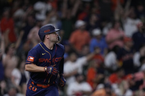 Houston Astros' Chas McCormick watches his three-run home run tie a baseball game during the seventh inning against the Texas Rangers, Monday, July 24, 2023, in Houston. (AP Photo/Kevin M. Cox)