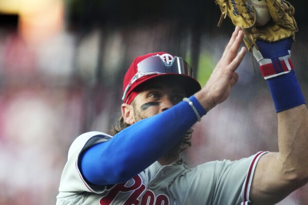 Philadelphia Phillies first baseman Bryce Harper catches a foul ball hit by Cleveland Guardians' Amed Rosario for an out in the third inning of a baseball game Friday, July 21, 2023, in Cleveland. (AP Photo/Sue Ogrocki)