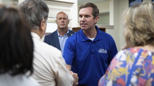 Gov. Andy Beshear meets with supporters after speaking at a reelection campaign stop at the Democratic Campaign Field Office at 400 E Main Ave. in Bowling Green, Ky., on Friday, July 14, 2023. Beshear pledged Friday to redouble his push for higher teacher pay and universal access to early childhood education if he wins reelection, offering a glowing assessment of Kentucky's future that he said was fueled by record economic development gains that have occurred on his watch. (Grace Ramey/Daily News via AP)