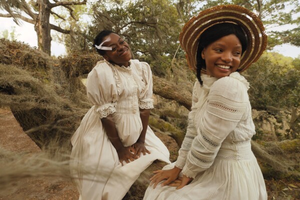 This image released by Warner Bros. Pictures shows Phylicia Pearl Mpasi, left, and Halle Bailey in a scene from "The Color Purple." (Warner Bros. Pictures via AP)