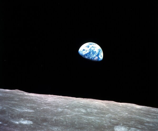 
              FILE - This Dec. 24, 1968, file photo made available by NASA shows the Earth behind the surface of the moon during the Apollo 8 mission. (William Anders/NASA via AP, File)
            