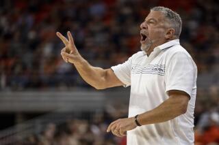 Auburn head coach Bruce Pearl signals in during the first half of an NCAA college basketball game against Yale, Saturday, Dec. 4, 2021, in Auburn, Ala. (AP Photo/Vasha Hunt)