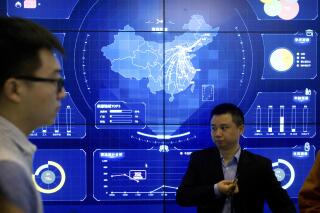 In this April 26, 2018, file photo, visitors stand in front of an electronic data display showing a map of China at the Global Mobile Internet conference in Beijing. China's industry ministry has announced a 6-month campaign to clean up what it says are serious problems with internet apps violating consumer rights, cyber security and "disturbing market order." (AP Photo/Mark Schiefelbein, File)