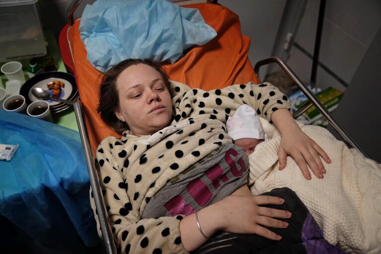 Mariana Vishegirskaya lies in a hospital bed after giving birth to her daughter Veronika, in Mariupol, Ukraine, Friday, March 11, 2022. Vishegirskaya survived the Russian airstrike on a children's and maternity hospital in Mariupol. (AP Photo/Evgeniy Maloletka)