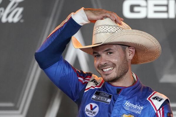 Kyle Larson puts on a cowboy hat as he celebrates in Victory Lane after winning the NASCAR Cup Series All-Star auto race at Texas Motor Speedway in Fort Worth, Texas, Sunday, June 13, 2021. (AP Photo/Tony Gutierrez)
