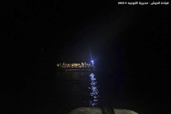 This photo released on Saturday, Sept. 23, 2023, by the Lebanese Army official website, shows a rubber boat with migrants during a rescue operation at the Mediterranean Sea, near the shores of the northern coastal town of Chekka, Lebanon. The Lebanese army and the country's civil defense recused early Saturday more than a few dozen migrants whose boat was sinking off the coast of north Lebanon, the military said in a statement. (Lebanese Army Website via AP)