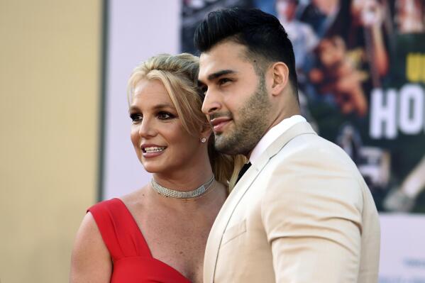 FILE - Britney Spears and Sam Asghari arrive at the Los Angeles premiere of "Once Upon a Time in Hollywood," at the TCL Chinese Theatre, Monday, July 22, 2019. Spears, less than five months after her conservatorship ended, confused some fans Monday, April 11, 2022, when she posted on Instagram that she's pregnant, and apparently married. (Photo by Jordan Strauss/Invision/AP, File)