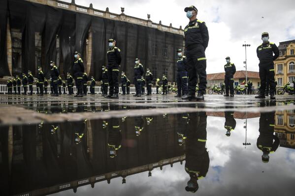 National Police attend a ceremony showing their new uniforms at Plaza de Bolivar in Bogota, Colombia, Monday, July 19, 2021. The uniforms changed from green to blue, and an arm patch features a QR code that allows anyone who scans it to see the officer's name, rank and badge number. (AP Photo/Ivan Valencia)