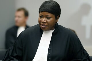 FILE - In this Tuesday Aug. 28, 2018 file photo, Prosecutor Fatou Bensouda at the International Criminal Court (ICC) in The Hague, Netherlands.  The ICC says its jurisdiction extends to territories occupied by Israel in the 1967 Mideast war, appearing to clear the way for its chief prosecutor to open a war crimes probe into Israeli military actions.  Bensouda, said in 2019 that there was a “reasonable basis” to open a war crimes probe into Israeli military actions in the Gaza Strip as well as Israeli settlement construction in the West Bank.  (Bas Czerwinski/Pool file via AP, File)