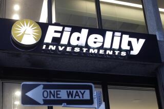 FILE - In this Oct. 14, 2019 file photo a Fidelity Investments logo is attached to a building, in Boston.  Fidelity is launching a new type of account for teenagers to save, spend and invest their money. The account is for 13- to 17-year-olds, and it will allow them to deposit cash, have a debit card and trade stocks and funds.  (AP Photo/Steven Senne, File)