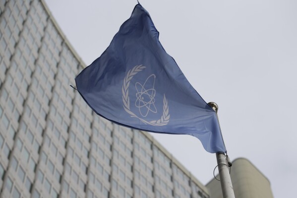 FILE - The flag of the International Atomic Energy Agency flies in front of its headquarters during an IAEA Board of Governors meeting in Vienna, Austria, Monday, Feb. 6, 2023. Iran has slowed its enrichment of uranium at nearly weapons-grade levels, a report by the United Nations' nuclear watchdog seen by The Associated Press said Monday, Sept. 4, 2023. (AP Photo/Heinz-Peter Bader, File)