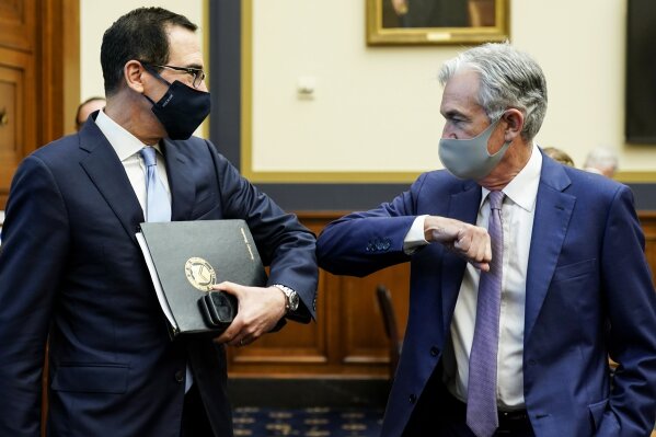 Treasury Secretary Steven Mnuchin, left, greets Federal Reserve Chair Jerome Powell with an elbow bump before the start of a House Financial Services Committee hearing about the government’s emergency aid to the economy in response to the coronavirus on Capitol Hill in Washington on Tuesday, Sept. 22, 2020. (Joshua Roberts/Pool via AP)