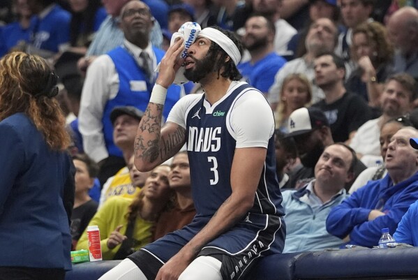 Dallas Mavericks forward Anthony Davis sits after getting inured during the first half of an NBA basketball game against the Atlanta Hawks in Dallas, Wednesday, April 2, 2025. (AP Photo/LM Otero)