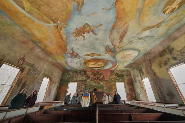 Visitors view the frescoes at the South Solon Meeting House, Sunday, April 6, 2025, in Solon, Maine. (AP Photo/Robert F. Bukaty)