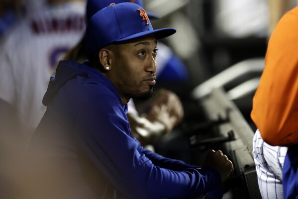 FILE - New York Mets' Edwin Diaz looks on from the dugout during the fifth inning of a baseball game against the Atlanta Braves on Aug. 13, 2023, in New York. Díaz is set to appear in a game for the first time since since tearing a patella tendon during the 2023 World Baseball Classic. The two-time All-Star is expected to be the first reliever after starter Tyler Megill and will have a 20-pitch limit when the Mets face Miami in spring training in Port St. Lucie, Florida, on Monday, March 11, 2024. (AP Photo/Adam Hunger, file)