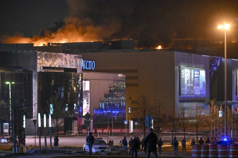 A massive blaze is seen over the Crocus City Hall on the western edge of Moscow, Russia, Friday, March 22, 2024. Several gunmen have burst into a big concert hall in Moscow and fired automatic weapons at the crowd, injuring an unspecified number of people and setting a massive blaze in an apparent terror attack days after President Vladimir Putin cemented his grip on the country in a highly orchestrated electoral landslide. (AP Photo/Dmitry Serebryakov)
