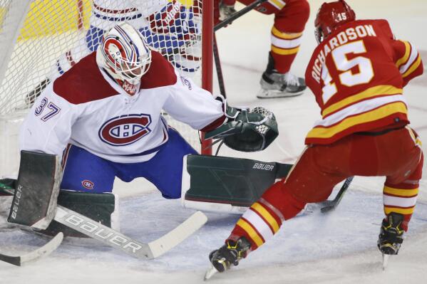 Montreal Canadiens goalie Andrew Hammond makes a save against Calgary Flames right wing Brad Richardson during the first period of an NHL hockey game Thursday, March 3, 2022, in Calgary, Alberta. (Larry MacDougal/The Canadian Press via AP)