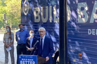 Democratic Gov. Tony Evers said that it was "outrageous" that Republicans planned to spend $680,000 on an investigation into the 2020 election in Wisconsin on Monday, Aug. 30, 2021, during a Democratic Party bus tour that stopped outside the state Capitol in Madison, Wisc. (AP Photo/Scott Bauer)