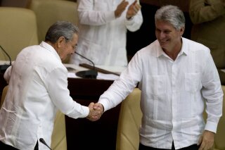 
              FILE - In this Dec. 20, 2014 file photo, Cuba's President Raul Castro, left, shakes hands with Vice President Miguel Diaz-Canel, at the closing of the legislative session at the National Assembly in Havana, Cuba. Cuban state media reported Monday, April 16, 2018, that the government has moved up the start of a session of the National Assembly in which Castro plans to step down and is expected to pass the presidency to the 57-year-old vice president. The session will now start Wednesday, April 17. (AP Photo/Ramon Espinosa, File)
            