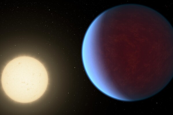 This illustration provided by NASA in 2017 depicts the planet 55 Cancri e, right, orbiting its star. A thick atmosphere has been detected around the planet that’s twice as big as Earth in a solar system about 41 light years away, researchers reported Wednesday, May 8, 2024. (NASA/JPL-Caltech via AP)