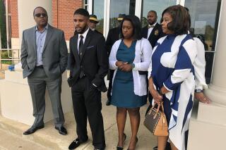 FILE - Brandon Calloway, second from left, speaks with a reporter alongside his family about his violent arrest in July for alleged traffic violations on Oct. 24, 2022, in Somerville, Tenn. Also pictured are Calloway's father, Ed Calloway, left, sister Raven Calloway, second from right, and mother, Dinishia Calloway, right. A grand jury declined to indict police officers after an investigation by the state’s police agency into the violent arrest of Brandon Calloway, a district attorney said Wednesday, Nov. 30, 2022. (AP Photo/Adrian Sainz, File)