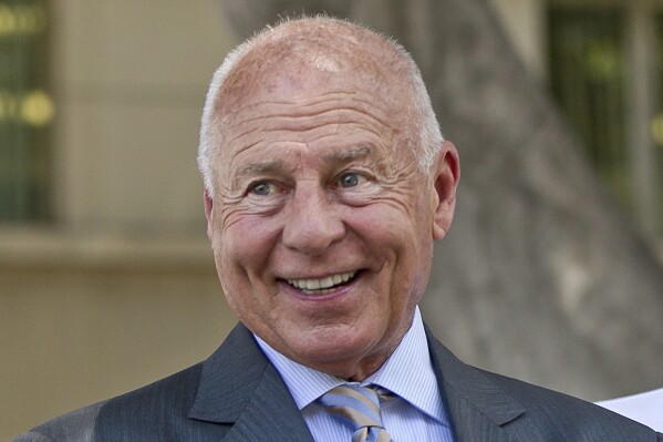 Attorney Tom Girardi smiles outside the Los Angeles courthouse, July 9, 2014. (AP Photo/Damian Dovarganes, File)