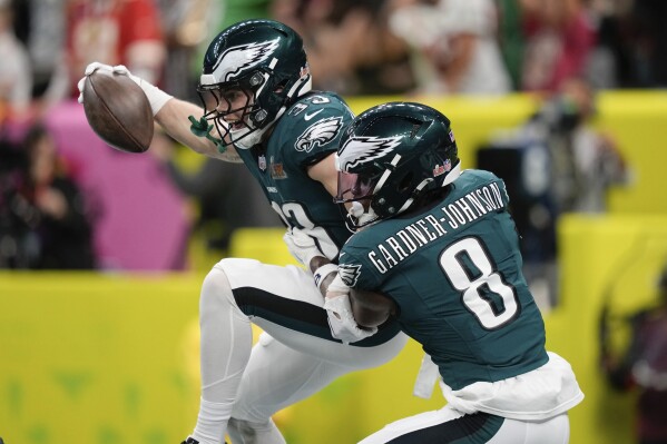 Philadelphia Eagles defensive back Cooper DeJean (33) celebrates with safety C.J. Gardner-Johnson (8) after intercepting a pass and scoring a touchdown during the first half of the NFL Super Bowl 59 football game, Sunday, Feb. 9, 2025, in New Orleans. (AP Photo/Matt Slocum)