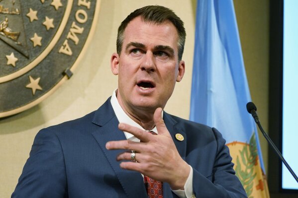 FILE - In this Feb. 11, 2021 file photo, Oklahoma Gov. Kevin Stitt speaks during a news conference in Oklahoma City. As the coronavirus swept across Oklahoma and the nation last spring, Gov. Kevin Stitt’s office was inundated with correspondence from frightened residents seeking stricter lockdowns to control the spread of the virus. At the same time, the governor was also weighing requests from dozens of business leaders asking him to make sure their businesses stayed open. (AP Photo/Sue Ogrocki File)