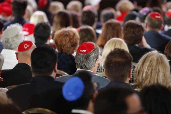 
              Attendees wear "Trump" yarmulkes before President Donald Trump speaks at an annual meeting of the Republican Jewish Coalition, Saturday, April 6, 2019, in Las Vegas. (AP Photo/John Locher)
            