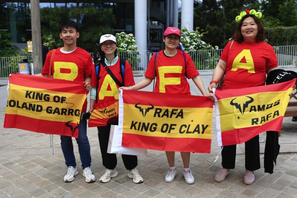 Fans of Spain's Rafael Nadal pose ahead of his first round match of the French Open tennis tournament against Germany's Alexander Zverev at the Roland Garros stadium in Paris, Monday, May 27, 2024. (AP Photo/Aurelien Morissard)