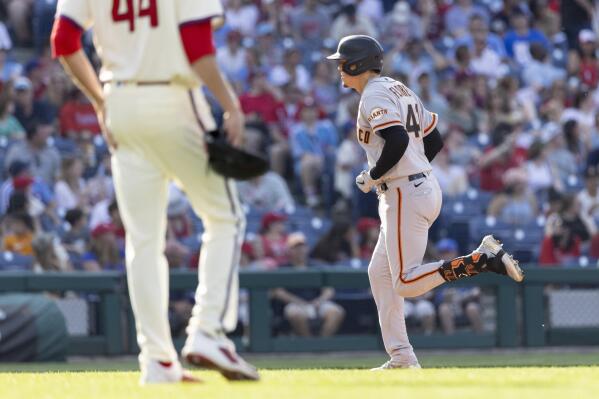San Francisco Giants' Wilmer Flores, right, runs the bases past Philadelphia Phillies starting pitcher Kyle Gibson (44) after hitting a two-un home run during the sixth inning of a baseball game, Monday, May 30, 2022, in Philadelphia. (AP Photo/Laurence Kesterson)