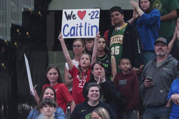 A young fan holds a sign for Indiana Fever guard Caitlin Clark during the second half of the Fever's WNBA basketball game against the Seattle Storm, Wednesday, May 22, 2024, in Seattle. The Storm won 85-83. (AP Photo/Jason Redmond)